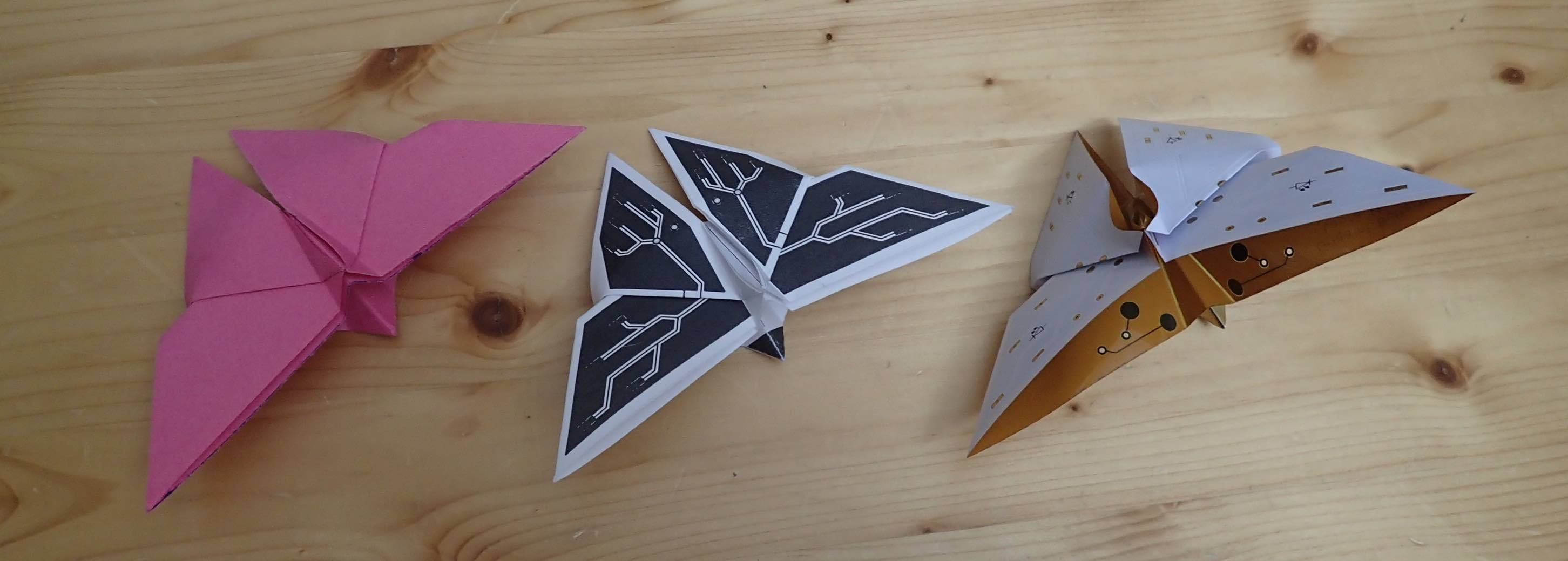 Photo of three origami butterflies, folded using origami paper, printer paper, and flexible PCB